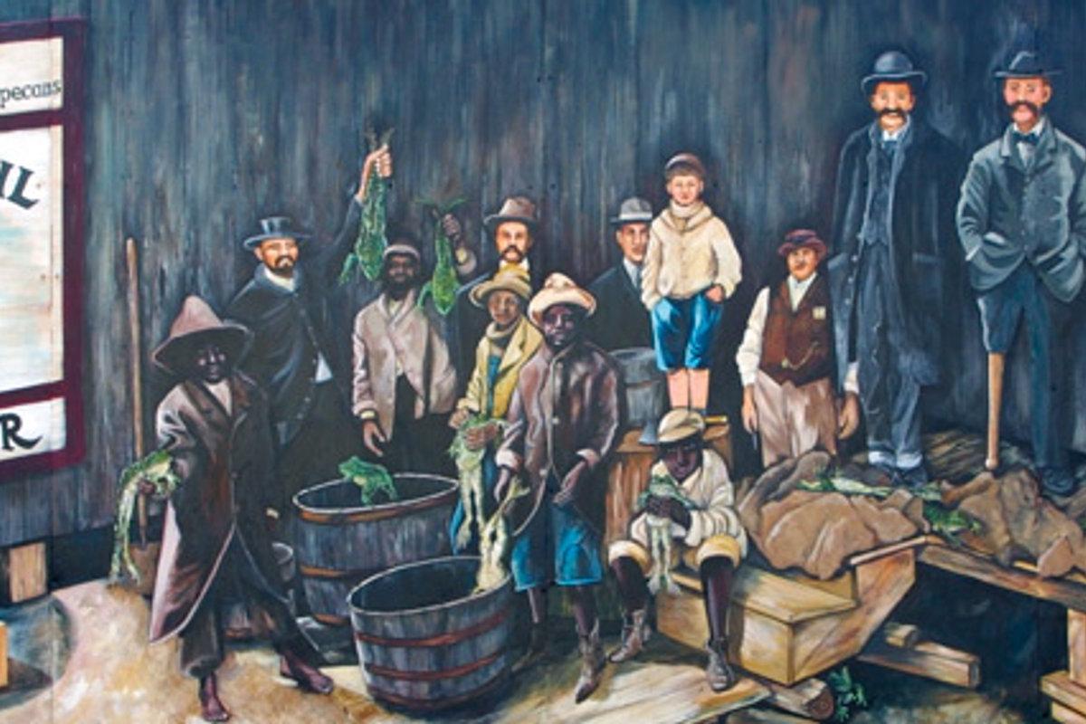 A historical Rayne mural depicting townspeople and workers from the frog-shipping era gathered with baskets of frogs.